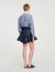Falda corta de denim con volantes